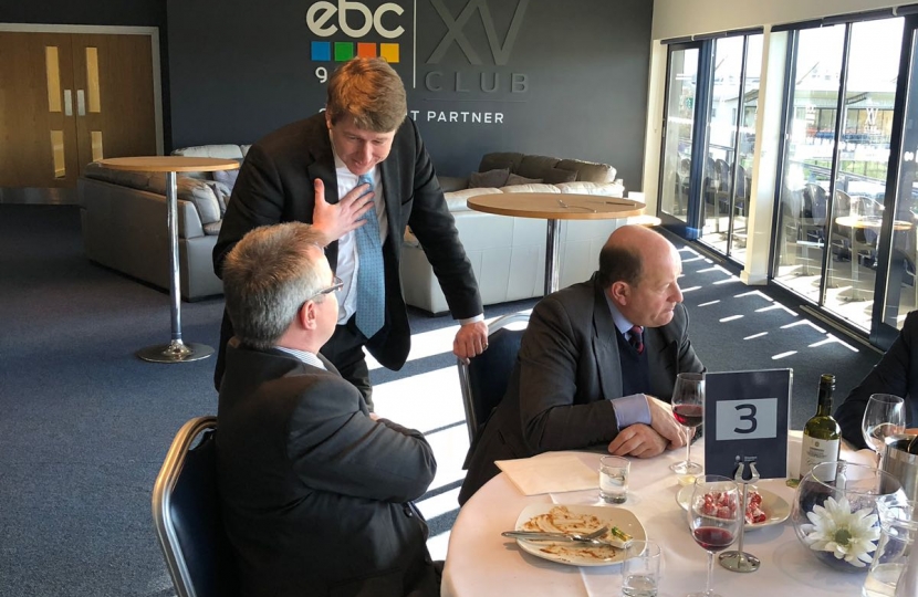 Robin Walker talking to a table of guests.